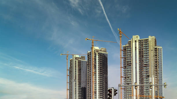 High-rise buildings under construction with cranes in a commercial real estate development area.