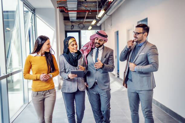 Group of professionals discussing real estate investments in a modern Dubai office building.