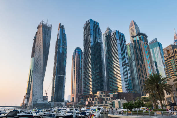 Skyscrapers and yachts in a modern cityscape, emphasizing urban real estate development and events.