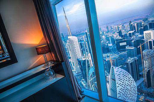 Scenic view of modern skyscrapers from a luxurious room in Damac Hills 2, highlighting urban architecture.